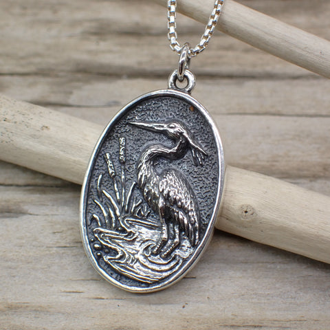 sterling silver heron charm in marsh