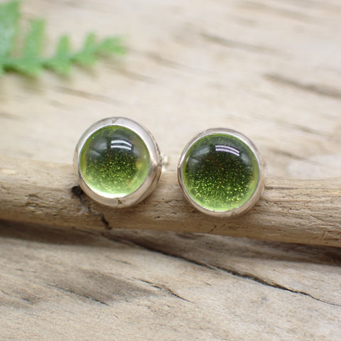 round peridot stud post earring on driftwood background