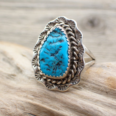 sterling silver stamped ring with bright blue sleeping beauty turquoise stone on driftwood