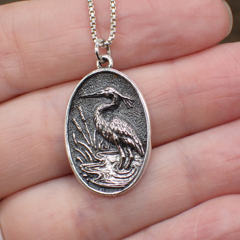 sterling silver heron charm in marsh