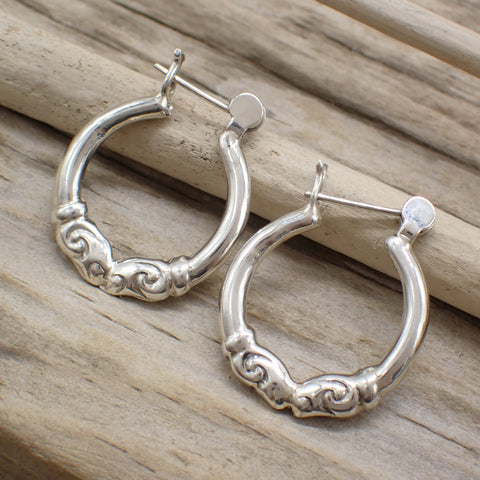 sterling silver patterned hoop earrings on driftwood